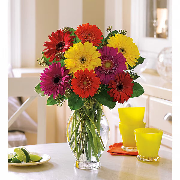 Bouquet of colorful flowers in a clear vase on a table