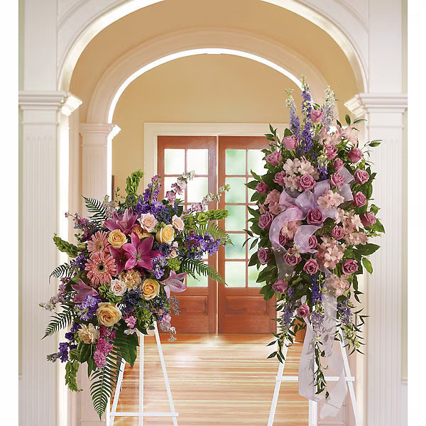 Two colorful flower arrangements on stands