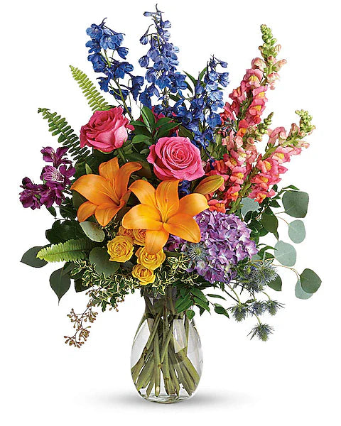 Vibrant mix of flowers in a clear vase for home decor